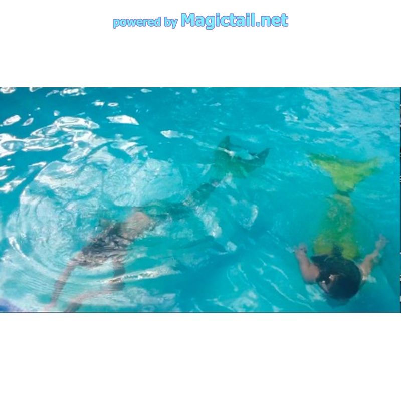 2 mermaids swimming